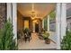 Inviting front porch featuring rocking chairs, pendant lighting, and a brick facade at 12912 Bailey Rd, Cornelius, NC 28031