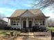 Charming duplex with inviting front porch and well-maintained landscaping on a sunny day at 13016 Meadowmere Rd, Huntersville, NC 28078