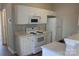 Well-lit kitchen with white cabinets and appliances, creating a clean and functional space at 13016 Meadowmere Rd, Huntersville, NC 28078