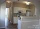 Bright kitchen featuring white appliances and ample cabinet space at 13016 Meadowmere Rd, Huntersville, NC 28078
