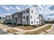 Street corner view featuring modern townhouses with manicured lawns and easy access to the neighborhood at 13304 Porter Creek Rd, Charlotte, NC 28262