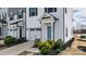 Charming townhouse with a light blue front door, attached garage, and neatly manicured shrubbery at 13304 Porter Creek Rd, Charlotte, NC 28262
