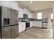 Modern kitchen with stainless steel appliances, white cabinets, and a gray backsplash at 13304 Porter Creek Rd, Charlotte, NC 28262