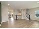 Spacious living area featuring wood flooring, open layout, and staircase at 13304 Porter Creek Rd, Charlotte, NC 28262