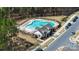 Aerial view of a community pool area with a pool house, fenced perimeter, and ample space for relaxation at 13304 Porter Creek Rd, Charlotte, NC 28262