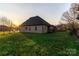 Expansive backyard features lush green grass and a beautiful brick home at sunset at 1358 37Th Avenue Ne Pl, Hickory, NC 28601