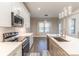 This modern kitchen features white cabinets, stainless steel appliances, and stone countertops with stylish pendant lights at 1358 37Th Avenue Ne Pl, Hickory, NC 28601