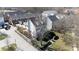 Aerial view of a two story house with dark roof, white fence and mature trees at 14024 Alley Son St, Huntersville, NC 28078