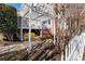 Cozy backyard retreat with a pergola, yellow patio set, and charming white picket fence at 14024 Alley Son St, Huntersville, NC 28078