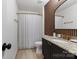 Bathroom featuring a shower and vanity with granite counters and panel accents at 14024 Alley Son St, Huntersville, NC 28078