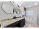 Bright bathroom featuring a tub, dual vanity with granite counters, and stylish mirrors at 14024 Alley Son St, Huntersville, NC 28078