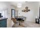 Bright dining area with unique wall art and a round table, complementing the adjacent kitchen and creating a cozy space at 14024 Alley Son St, Huntersville, NC 28078