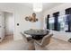Bright dining room featuring modern lighting, decorative wall art, and a round table set for four, ideal for intimate gatherings at 14024 Alley Son St, Huntersville, NC 28078