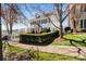 Beautiful home on a sunny day, framed by lush green bushes and a white picket fence at 14024 Alley Son St, Huntersville, NC 28078