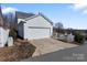Detached two-car garage, set alongside a paved driveway and manicured landscaping at 14024 Alley Son St, Huntersville, NC 28078