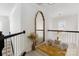 Sitting area hallway with tall mirror, plush stool and bright window at 14024 Alley Son St, Huntersville, NC 28078