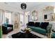 Stylish living room featuring elegant mirrors, a green sofa, and sophisticated decor at 14024 Alley Son St, Huntersville, NC 28078