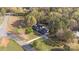 Expansive aerial view of a charming two-story home nestled among mature trees and a well-manicured lawn at 14124 Hiwassee Rd, Huntersville, NC 28078