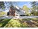 Backyard with lush greenery, a patio, and a deck, ideal for entertaining at 14124 Hiwassee Rd, Huntersville, NC 28078