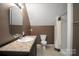 Bathroom with a corner shower, neutral walls, and unique mirror at 14124 Hiwassee Rd, Huntersville, NC 28078