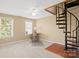 Spacious bedroom featuring a unique spiral staircase, a ceiling fan, and natural light through a window at 14124 Hiwassee Rd, Huntersville, NC 28078