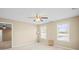 Bright bedroom with two windows, neutral carpet, ceiling fan, and simple furniture setup for a clean, minimalist appeal at 14124 Hiwassee Rd, Huntersville, NC 28078