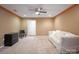 Bedroom featuring neutral walls, plush carpeting, modern ceiling fan, and walk-in closet at 14124 Hiwassee Rd, Huntersville, NC 28078