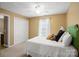 Cozy bedroom with soft carpet, a comfortable bed, a closet, and a window with natural lighting at 14124 Hiwassee Rd, Huntersville, NC 28078