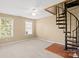 Spacious bedroom featuring a unique spiral staircase, a ceiling fan, and lots of open space at 14124 Hiwassee Rd, Huntersville, NC 28078