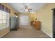 Versatile bonus room with a ceiling fan, neutral carpet, and a variety of furniture at 14124 Hiwassee Rd, Huntersville, NC 28078