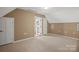Bright bonus room featuring neutral carpeting, paint, and natural light from glass pane door at 14124 Hiwassee Rd, Huntersville, NC 28078