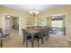 Open dining room with a chandelier, large table, and connection to the living room at 14124 Hiwassee Rd, Huntersville, NC 28078