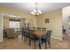 Spacious dining area with hardwood table and chairs next to a living room with an indoor ceiling fan at 14124 Hiwassee Rd, Huntersville, NC 28078