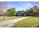 Spacious front yard with mature trees leads to a grand brick home at 14124 Hiwassee Rd, Huntersville, NC 28078