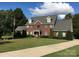 Charming two-story brick home with dormer windows and landscaped front yard at 14124 Hiwassee Rd, Huntersville, NC 28078