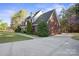 Side view of a brick home showcasing its architectural details and landscaping at 14124 Hiwassee Rd, Huntersville, NC 28078