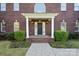 Home's front entrance with well-manicured bushes and a symmetrical brick facade at 14124 Hiwassee Rd, Huntersville, NC 28078