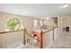 Bright hallway featuring a grand chandelier, staircase, and views of two bedrooms and spiral staircase at 14124 Hiwassee Rd, Huntersville, NC 28078