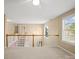 Bright hallway featuring a staircase, chandelier, and a window with a view of the outdoors at 14124 Hiwassee Rd, Huntersville, NC 28078