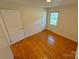 A bedroom featuring hardwood floors and a window providing natural light at 2020 Parkdale Ave, Gastonia, NC 28052