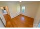 Bedroom highlighting hardwood floors and open doorway leading to another area at 2020 Parkdale Ave, Gastonia, NC 28052