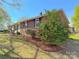 Charming home features a brick exterior, beautiful landscaping, and vibrant flowering bushes at 2020 Parkdale Ave, Gastonia, NC 28052