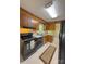 Cozy kitchen featuring wood cabinets, black appliances, and bright countertops with neutral flooring at 2020 Parkdale Ave, Gastonia, NC 28052