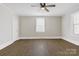 Bedroom featuring wood-look floors, a ceiling fan, and white trim at 209 N Yadkin Ave, Spencer, NC 28159