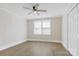 Spacious bedroom with a ceiling fan, closet, and natural light from the window at 209 N Yadkin Ave, Spencer, NC 28159