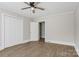 Bright bedroom featuring wood-look flooring, a ceiling fan, and ample closet space at 209 N Yadkin Ave, Spencer, NC 28159