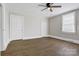 Bedroom featuring wood-look floors, white trim, a ceiling fan, and window with blinds at 209 N Yadkin Ave, Spencer, NC 28159