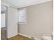 Neutral bedroom with wood-look floors, closet, and natural light from the window at 209 N Yadkin Ave, Spencer, NC 28159