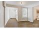 Inviting entryway with vinyl floors, neutral paint, and natural light from the window at 209 N Yadkin Ave, Spencer, NC 28159