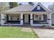Inviting single-story home with a classic covered front porch, painted brick columns, and manicured lawn at 209 N Yadkin Ave, Spencer, NC 28159